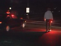 Volunteers directing traffic with flares