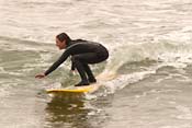 Lori crouching on a longboard